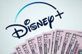 Disney logo on a screen covered with money