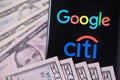 Google and Citigroup logos on screen and money. Illustrative photo for news that Google partnered with Citibank in project called