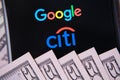 Google and Citigroup logos on screen and money. Illustrative photo for news that Google partnered with Citibank in project called