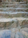 Stone stair with cemented grey steps pattern. Brown staircase ri