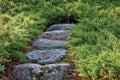 Stone stair pathway trail steps, grey and red colorful granite rock stairway pavement path in sunny summer garden, large detailed Royalty Free Stock Photo