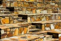 Stone stair steps interrupt outdoor bench seating on brown sandstone rocks