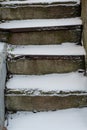 The stone staircase is covered with snow. Concept, winter has come, cautiously slippery. Royalty Free Stock Photo