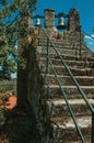 Stone staircase with iron railing and bronze bells