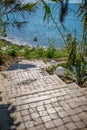 Stone staircase leads through a passageway down to the sea Royalty Free Stock Photo