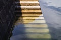 a stone staircase leads into the water on a quay Royalty Free Stock Photo