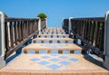 Stone staircase railing made of wood and blue sky. Royalty Free Stock Photo