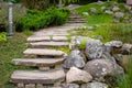 Stone staircase with steps made of wild natural stone on slope of hill park landscape.