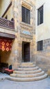 Stone staircase and wooden door leading to old Mamluk era Beit El Sennary building, Cairo, Egypt