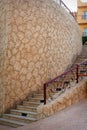 Stone stairs along the stone wall Royalty Free Stock Photo