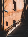 Stone stairs in the city, sunlight on wall, stairs in shade Royalty Free Stock Photo