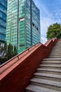 Stone stairs and facades of modern office buildings made of glass and aluminum