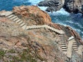 Stone stairs in rock leading down to the sea. Ancient stone steps in the rock. Stairs to the sea. Nature, cliffs and coastline Royalty Free Stock Photo