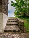 Stone stairs with a small stone wall at the side of the building Royalty Free Stock Photo