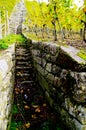 Stone stairs and stone wall with blurred autumn vines behind  2 Royalty Free Stock Photo