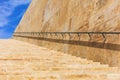 Stone stairs and wall with metal rail in the historic center of Valletta, Malta. Blue sky background Royalty Free Stock Photo