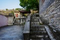 Stone stairway before ancient tile-roofed buildings in morning