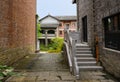 Stone stairway at side door of old-fashioned building in cloudy