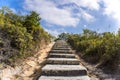 Stone stairway, stair, trail, footpath, country road in the mountain as background