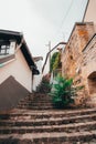 Stone stairway with a wrought iron railing leading up to an outdoor patio area