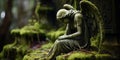 Stone statue of an angel weeping, set in an old cemetery covered in moss