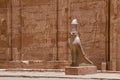 Stone statue of the bird representing Horus at the entrance to the temple of Edfu in Egypt. Royalty Free Stock Photo