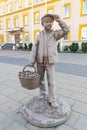 Stone statue of boy with wicker basket full of mushrooms Royalty Free Stock Photo