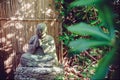 Stone Statue of Buddhist Monk Sitting in Meditation in japanese garden. Exterior,outdoor decor. Relax and mind calm concept. Royalty Free Stock Photo