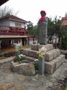 Stone statue of a deity and surrounding oriental decoration in a Japanese Buddhist temple Royalty Free Stock Photo