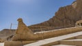 A stone statue of a falcon at the entrance of the ancient funerary temple