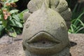 A stone statue of a fish