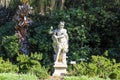 A Stone Statue In The Garden Of A Roman Soldier Surrounded By Lush Green Trees