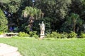 A Stone Statue In The Garden Of A Roman Soldier Surrounded By Lush Green Trees