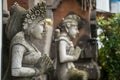 Stone statue with hands in a praying atthe temple' entrance on Bali, Indonesia