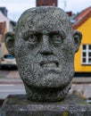 Stone statue making weird funny face. Close up image