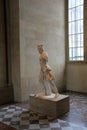 Stone statue set on stand near window, The Louvre,Paris,France,2016 Royalty Free Stock Photo