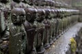 stone statues of Ksitigarbha bodhisattva (Jizo) at Hasedera Temple, Kamakura, Japan on a rainy day Royalty Free Stock Photo