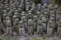 stone statues of Ksitigarbha bodhisattva (Jizo) at Hasedera Temple, Kamakura, Japan on a rainy day