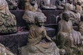 Stone statues of a seated Buddhist monks close-up