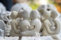 Stone statuette of a couple in love with a heart inside. Souvenir on display for sale on street market in Ubud, Bali, Indonesia