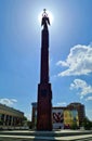 Stone stele and an image of Angel with cross against the backdrop of the bright sun in Russian city of Stavropol in
