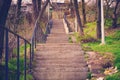 Stone steps and iron rails go up in the park. Royalty Free Stock Photo
