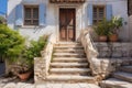 stone steps leading up to the front door of a mediterranean home with balcony Royalty Free Stock Photo