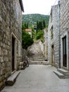 Steps rising through the village of Ston in Croatia with a view of the walls at the top