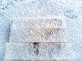 Stone steps. Staircase without railings. In the air first snow. Footprints on the first snow. The steps are icy, covered with snow Royalty Free Stock Photo