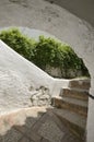 Stairs under white arch