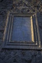 Stone sundial and roman numerals on old stone wall facade vertically Royalty Free Stock Photo