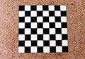 The stone table has a white and black checkerboard