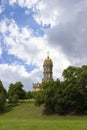 Stone temple with a high belfry, one golden dome and a golden Christian cross on top. Beautiful majestic orthodox Royalty Free Stock Photo