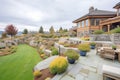 stone terraced backyard of a shinglestyle hillside home